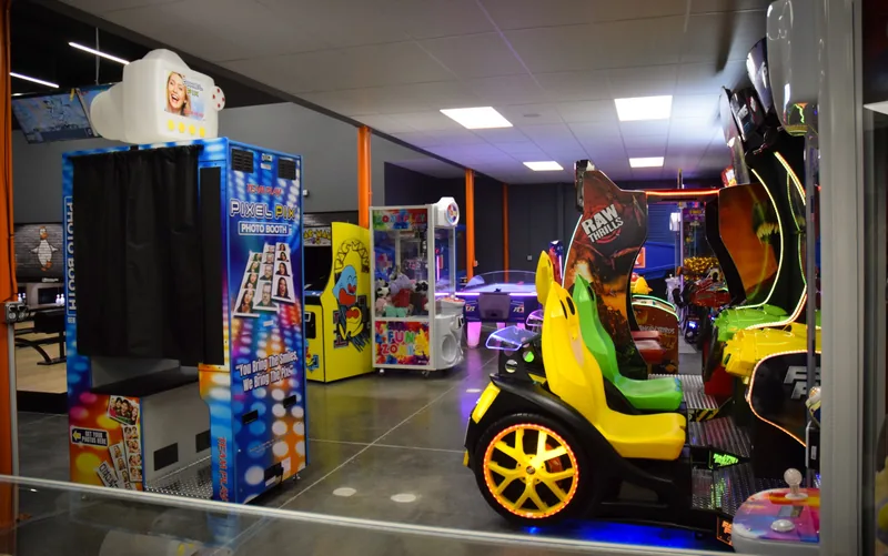 The photo booth and prize claw machines on Funder Alley's arcade floor