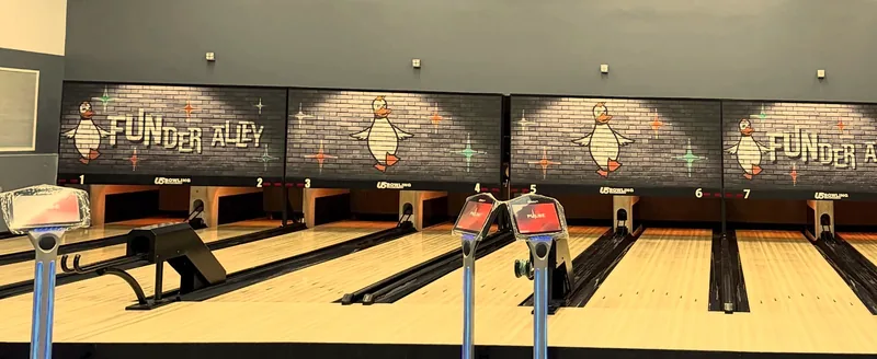 A wide view along Funder Alley's duckpin lanes and the row of duck murals